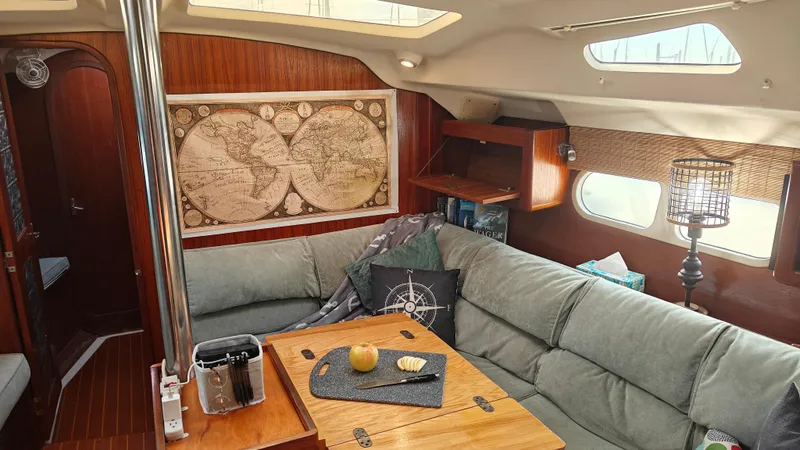 Slide: The Image of Cozy interior of 1998 Hunter 410 sailboat with map decor and comfortable seating. - 44