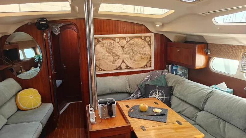 Slide: The Image of Cozy interior of a 1998 Hunter 410 sailboat with map decor and comfortable seating. - 45