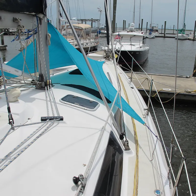 Slide: The Image of Sailboat Hunter 410, 1998 model, docked with blue sunshade, marina background. - 5