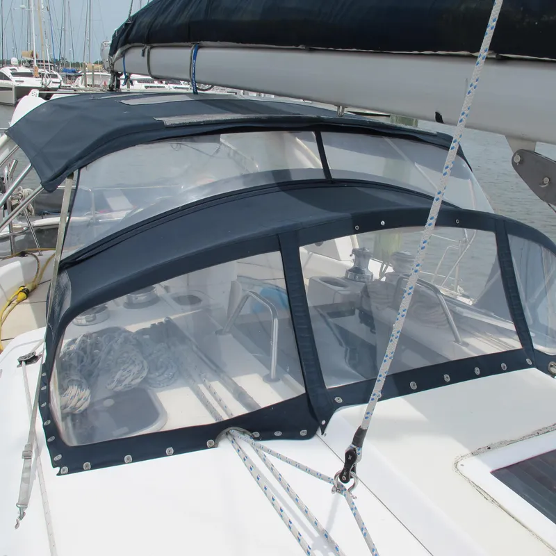 Slide: The Image of 1998 Hunter 410 sailboat with protective cockpit enclosure and visible rigging. - 7