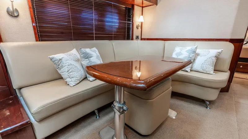 Slide: The Image of Luxurious interior of 2008 Sea Ray Sundancer with elegant seating and wooden table. - 10