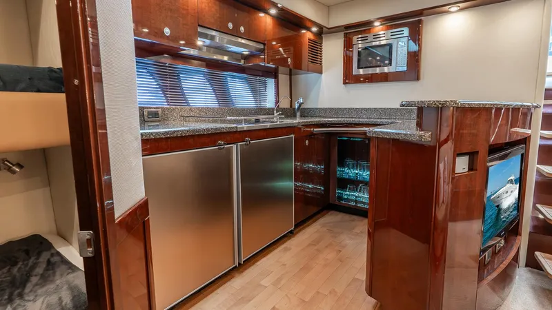 Slide: The Image of Luxurious 2008 Sea Ray Sundancer yacht interior with modern kitchen and wood finishes. - 11
