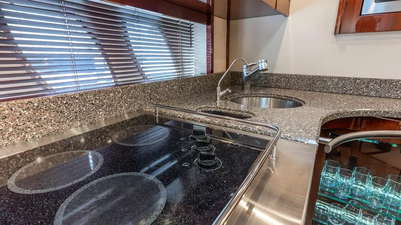 Slide: The Image of Luxurious 2008 Sea Ray Sundancer yacht kitchen with modern stovetop and sleek countertops. - 13