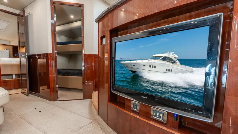 Slide: The Image of Luxurious interior of 2008 Sea Ray Sundancer yacht with TV and wood paneling. - 19
