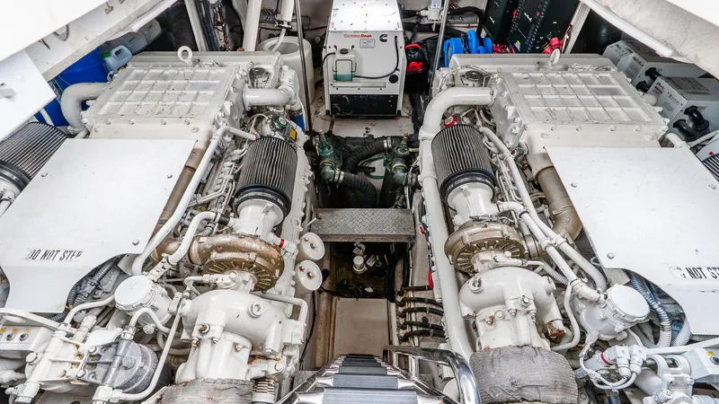 Slide: The Image of Engine room of a 2008 Sea Ray Sundancer yacht, showcasing dual engines and mechanical components. - 31