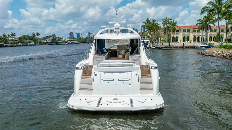 Slide: The Image of 2008 Sea Ray Sundancer yacht on a scenic waterway with palm trees and luxury homes. - 34