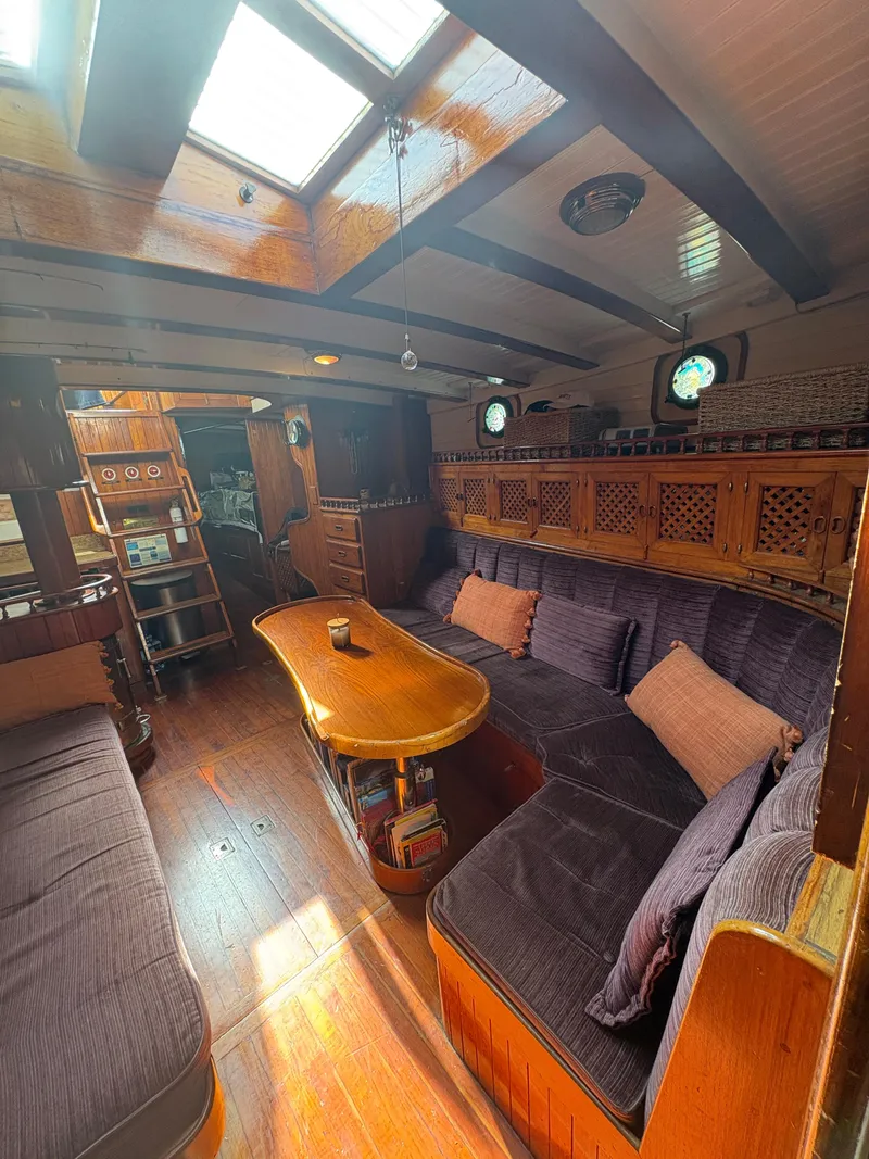 Slide: The Image of Interior of a 1975 Formosa 51 yacht with cozy seating and wooden finishes. - 10