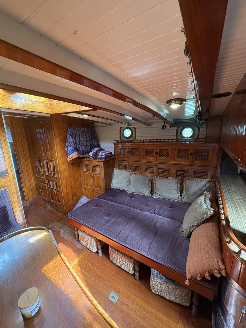 Slide: The Image of Interior of 1975 Formosa 51 yacht with cozy seating and wooden accents. - 11