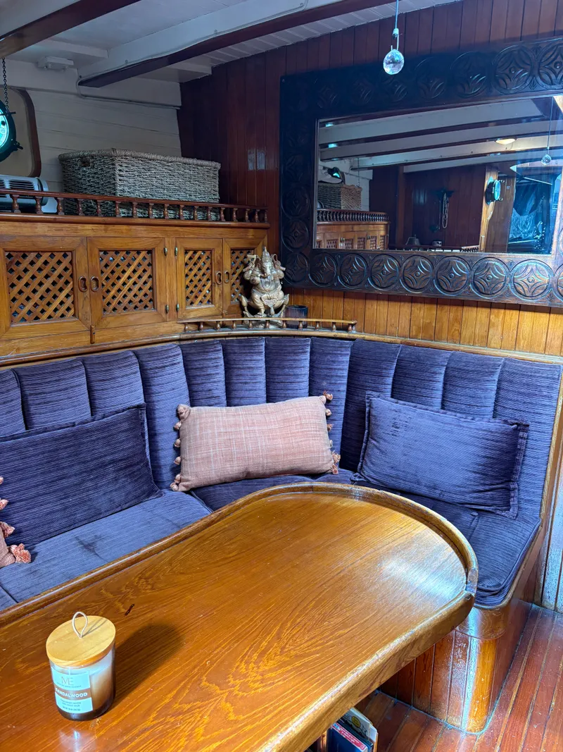 Slide: The Image of Cozy interior of 1975 Formosa 51 yacht with plush seating and wooden accents. - 12