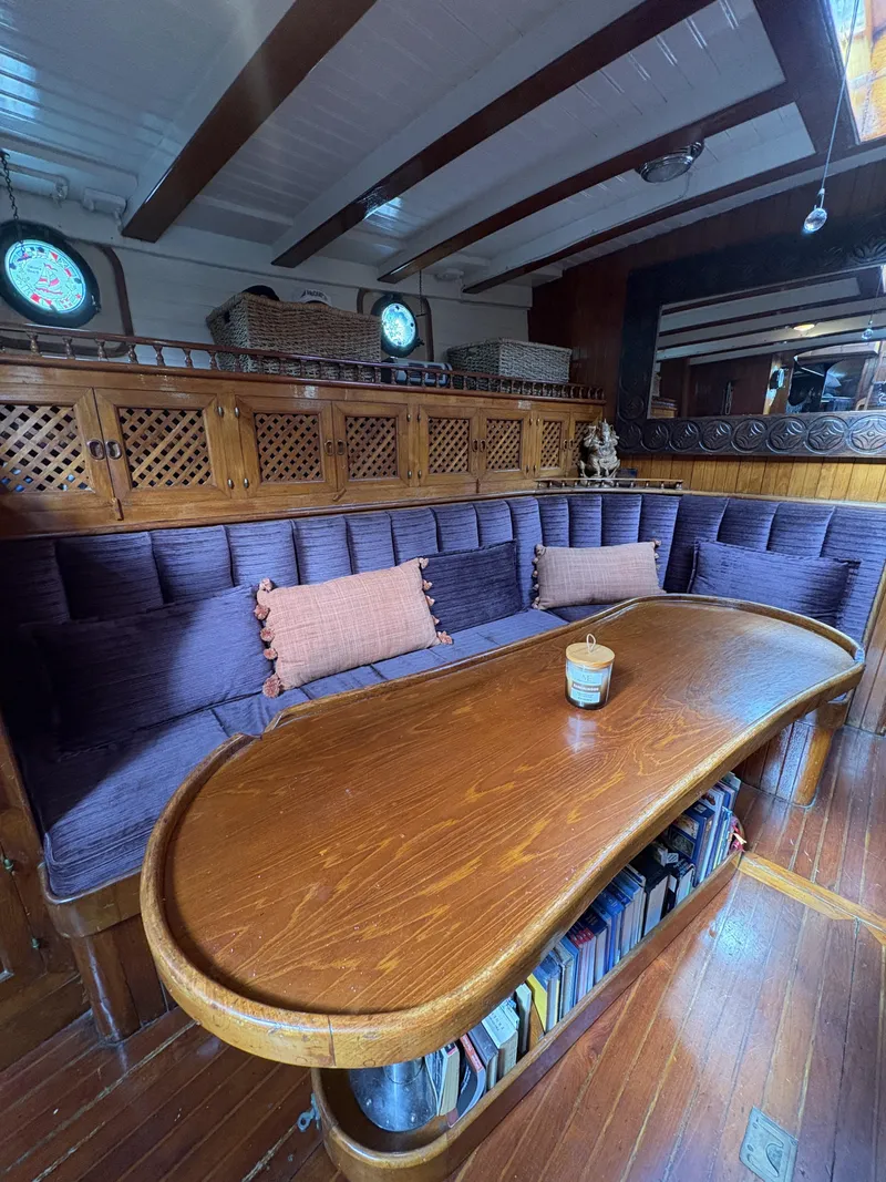 Slide: The Image of Interior of 1975 Formosa 51 yacht with wooden table, cushioned seating, and nautical decor. - 13