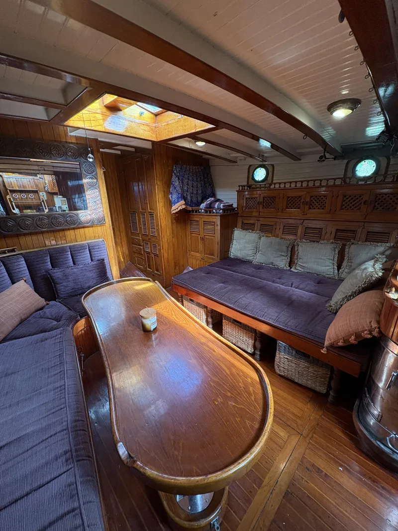 Slide: The Image of Interior of 1975 Formosa 51 yacht with wooden furnishings and cozy seating area. - 14