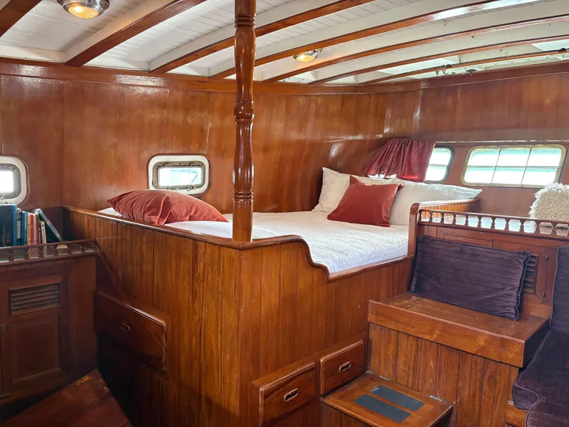 Slide: The Image of Interior of 1975 Formosa 51 yacht with wooden paneling and cozy bed. - 15