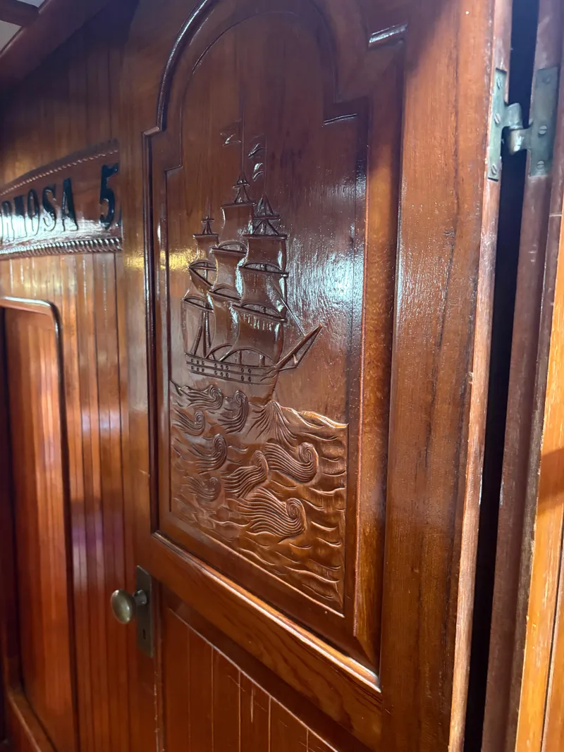 Slide: The Image of Wooden door with carved ship design on a 1975 Formosa 51 yacht. - 18