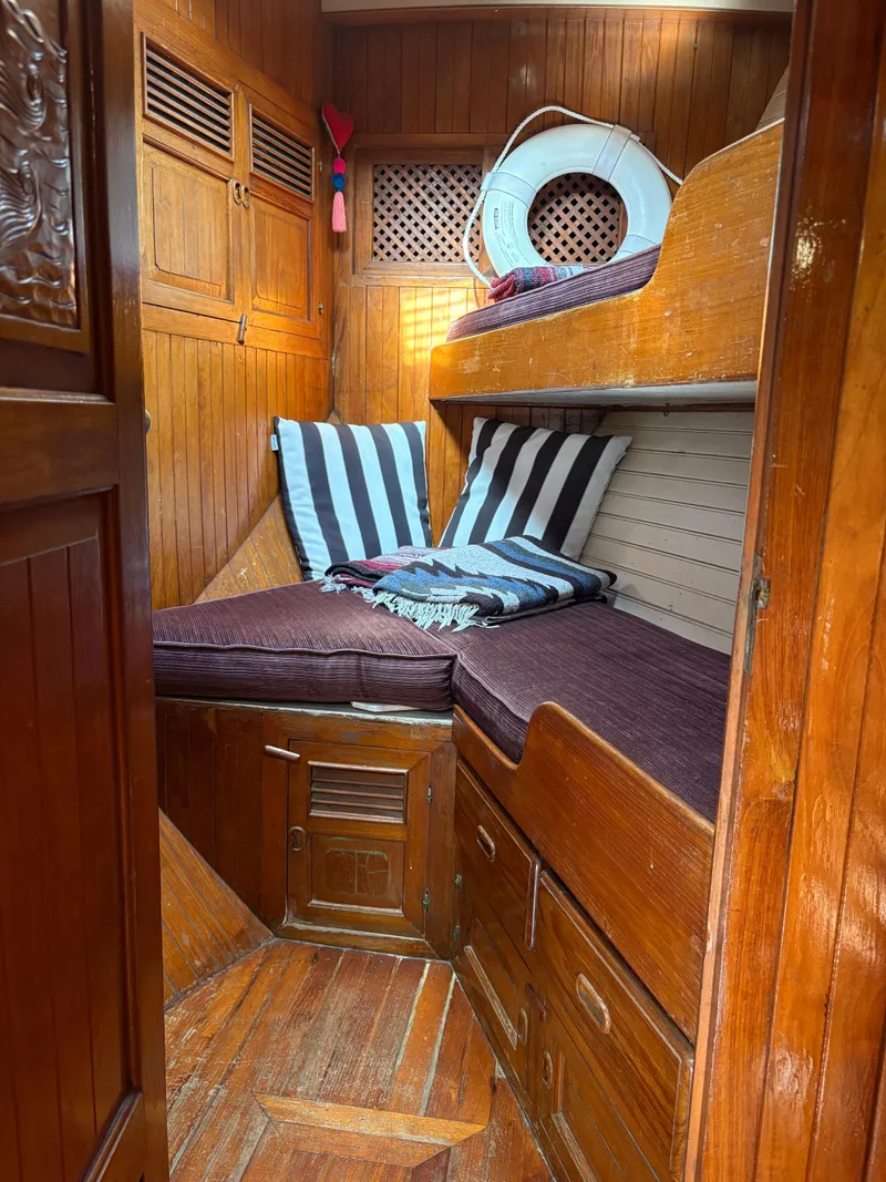 Slide: The Image of Cozy wooden cabin interior of 1975 Formosa 51 yacht with striped cushions and life preserver. - 19