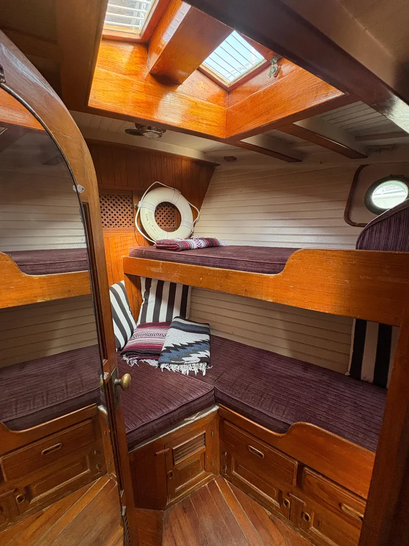 Slide: The Image of Cozy cabin interior of 1975 Formosa 51 sailboat with wooden bunk beds and skylight. - 21
