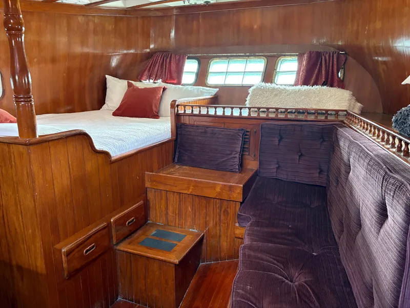 Slide: The Image of Interior of 1975 Formosa 51 yacht with wooden furnishings and cozy seating area. - 23