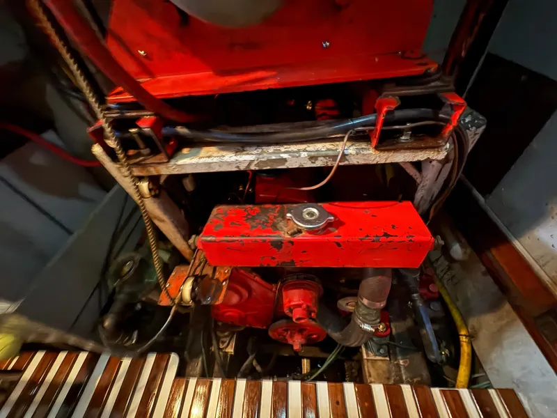 Slide: The Image of Engine compartment of a 1975 Formosa FORMOSA 51 sailboat, featuring a red-painted engine. - 28