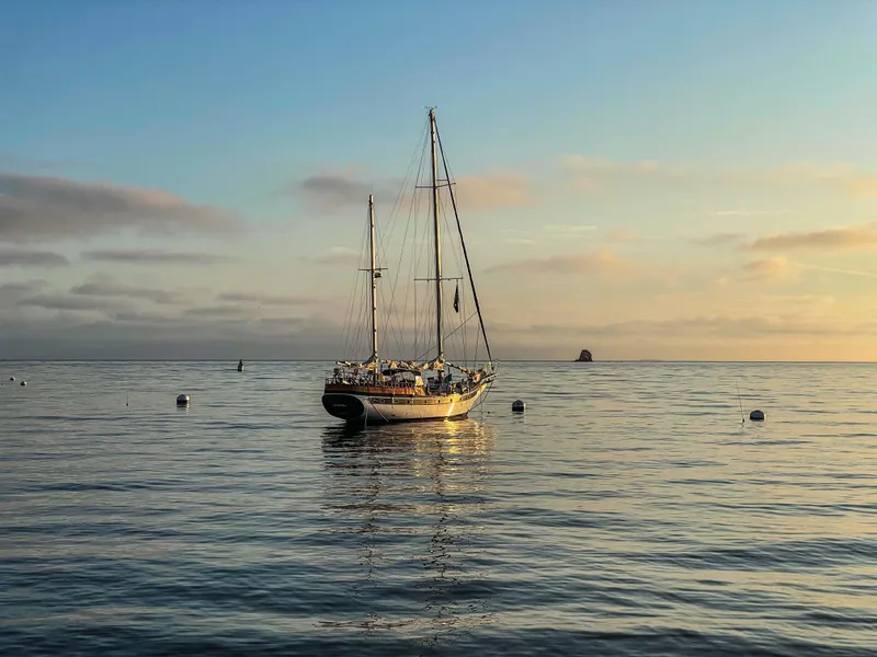 Slide: The Image of Sailboat Formosa 51 from 1975 on calm sea at sunset. - 4