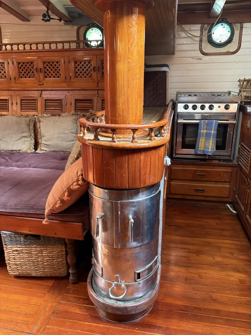 Slide: The Image of Vintage 1975 Formosa 51 yacht interior with wood stove and cozy furnishings. - 7