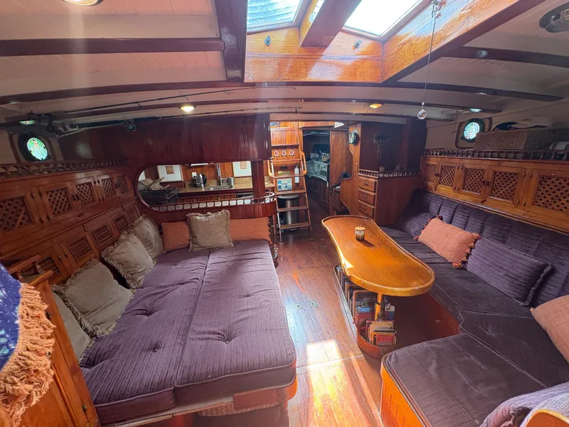 Slide: The Image of Interior of a 1975 Formosa 51 yacht with cozy seating and wooden decor. - 8