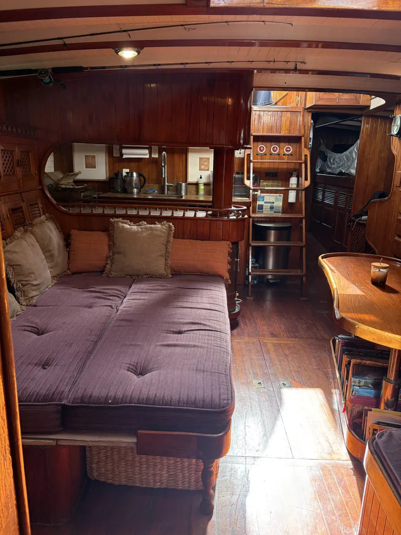 Slide: The Image of Interior of a 1975 Formosa 51 yacht with wooden furnishings and cozy seating area. - 9