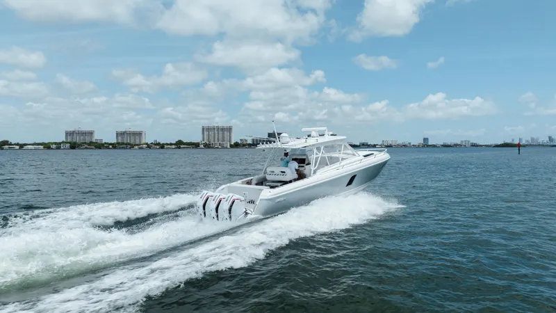 Slide: The Image of 2013 Intrepid 400 Cuddy cruising on open water under a clear blue sky. - 16
