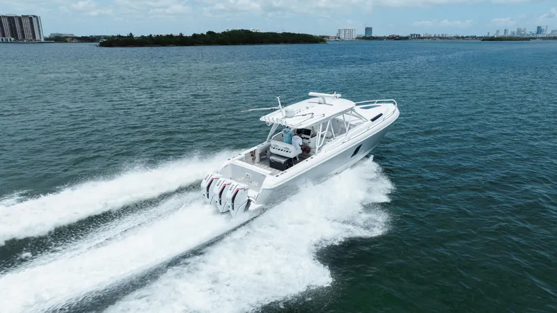 Slide: The Image of 2013 Intrepid 400 Cuddy cruising on open water, showcasing powerful engines and sleek design. - 18