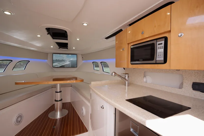 Slide: The Image of Interior of 2013 Intrepid 400 Cuddy yacht with kitchenette and seating area. - 21
