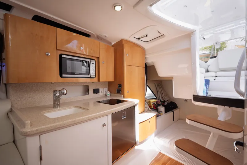 Slide: The Image of Interior of 2013 Intrepid 400 Cuddy boat with kitchenette and seating area. - 24