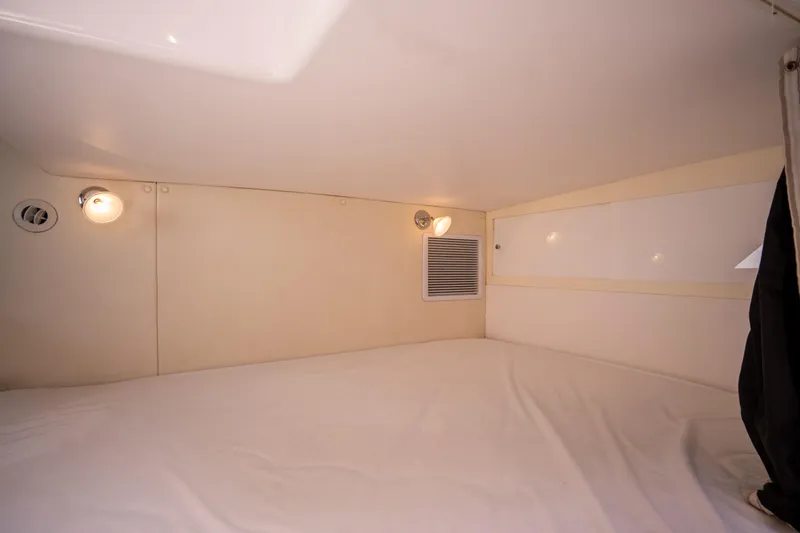 Slide: The Image of Interior cabin of 2013 Intrepid 400 Cuddy, featuring cozy sleeping area with lighting. - 26