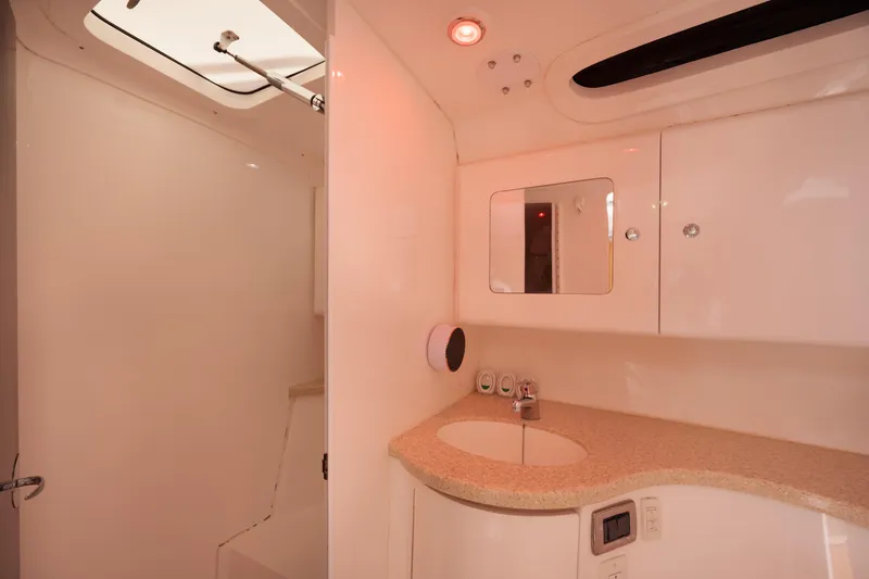 Slide: The Image of 2013 Intrepid 400 Cuddy bathroom with sink, mirror, and modern fixtures. - 27