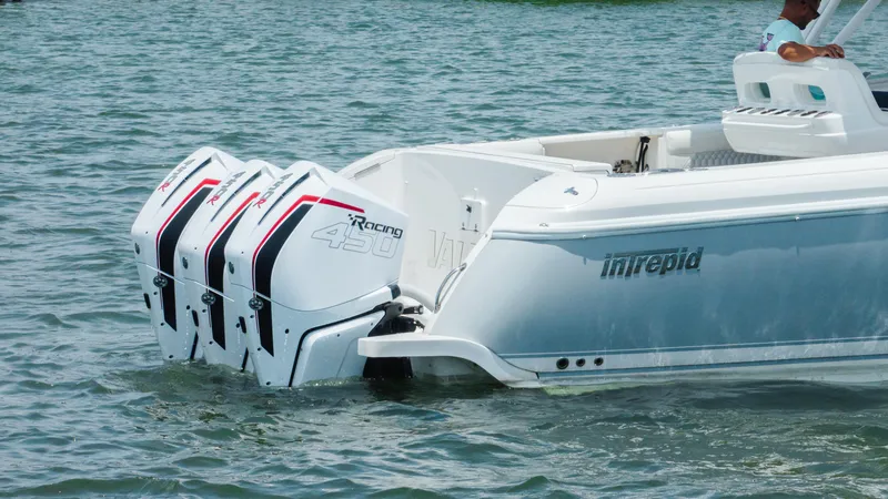 Slide: The Image of 2013 Intrepid 400 Cuddy boat with triple outboard engines on water. - 3