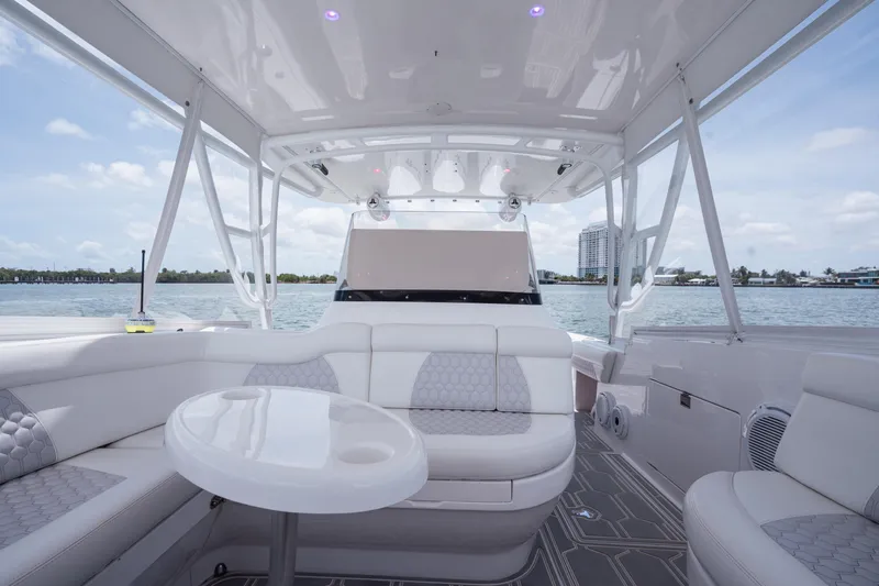 Slide: The Image of Luxurious 2013 Intrepid 400 Cuddy boat interior with seating and table, overlooking serene waters. - 35