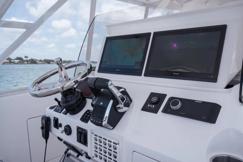 Slide: The Image of Control panel of 2013 Intrepid 400 Cuddy boat with dual screens and steering wheel. - 38