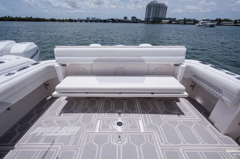 Slide: The Image of 2013 Intrepid 400 Cuddy boat with spacious deck and seating, overlooking calm waters. - 39