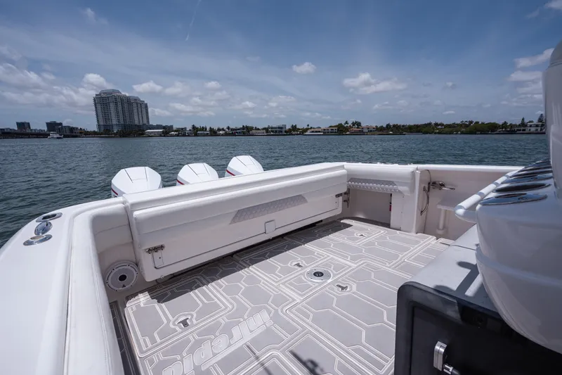 Slide: The Image of 2013 Intrepid 400 Cuddy boat deck with scenic waterfront view. - 41