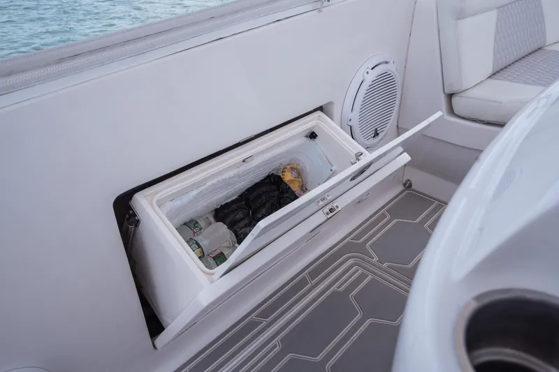 Slide: The Image of Built-in cooler on 2013 Intrepid 400 Cuddy boat, open with drinks inside. - 42