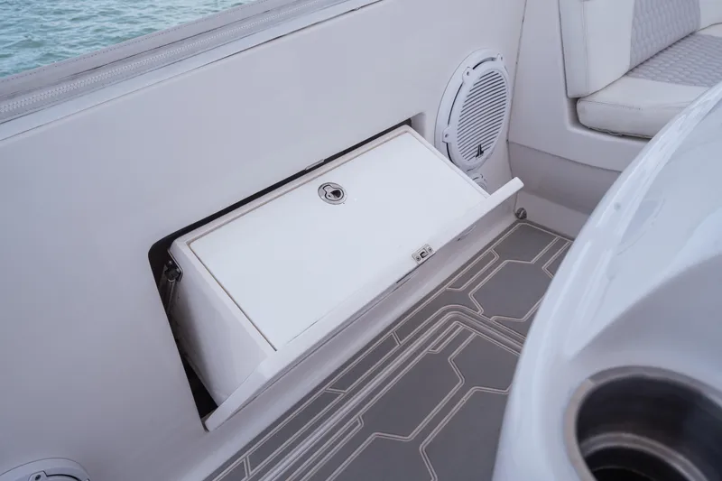 Slide: The Image of 2013 Intrepid 400 Cuddy boat interior with storage compartment and speaker. - 43