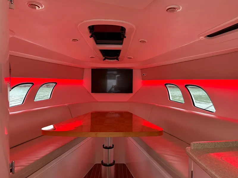 Slide: The Image of Interior of 2013 Intrepid 400 Cuddy with red lighting and seating area. - 48