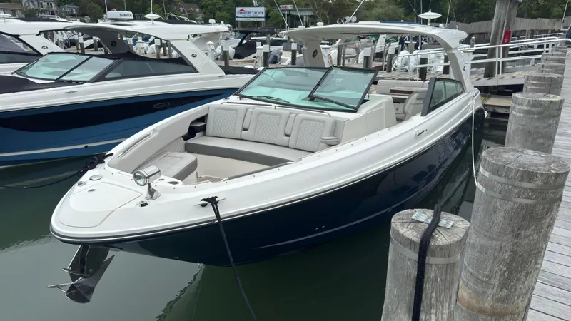 Slide: The Image of 2020 Sea Ray SLX 400 boat docked at marina, featuring sleek design and spacious seating. - 1
