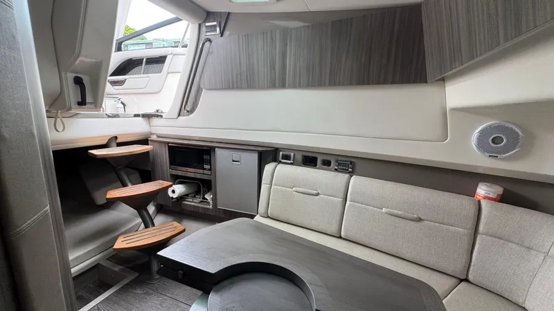 Slide: The Image of Interior of 2020 Sea Ray SLX 400 yacht with modern seating and wooden steps. - 17