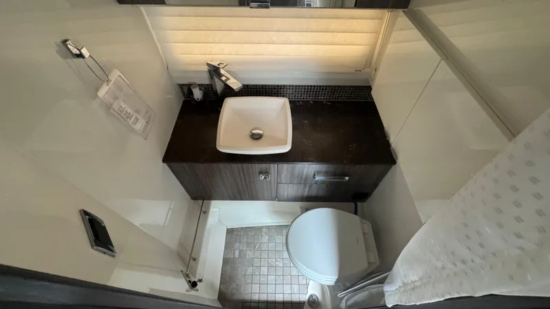 Slide: The Image of 2020 Sea Ray SLX 400 bathroom with modern sink, toilet, and sleek design. - 19