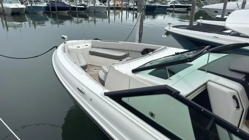 Slide: The Image of 2020 Sea Ray SLX 400 boat docked in a marina, showcasing sleek design and spacious seating. - 21