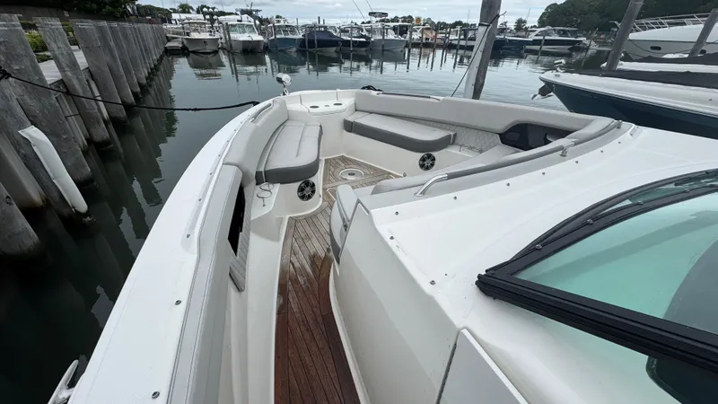 Slide: The Image of 2020 Sea Ray SLX 400 boat docked, featuring spacious seating and sleek design. - 22