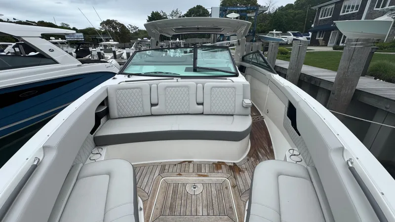 Slide: The Image of 2020 Sea Ray SLX 400 boat with spacious seating and elegant design at a marina. - 23