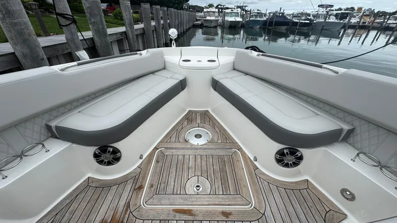 Slide: The Image of 2020 Sea Ray SLX 400 boat interior with cushioned seating and wooden deck. - 24
