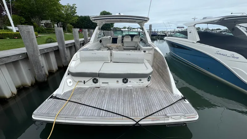 Slide: The Image of 2020 Sea Ray SLX 400 luxury boat docked at marina, rear view. - 4