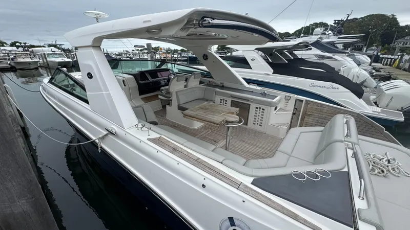 Slide: The Image of 2020 Sea Ray SLX 400 luxury yacht docked at marina, featuring spacious seating and sleek design. - 5