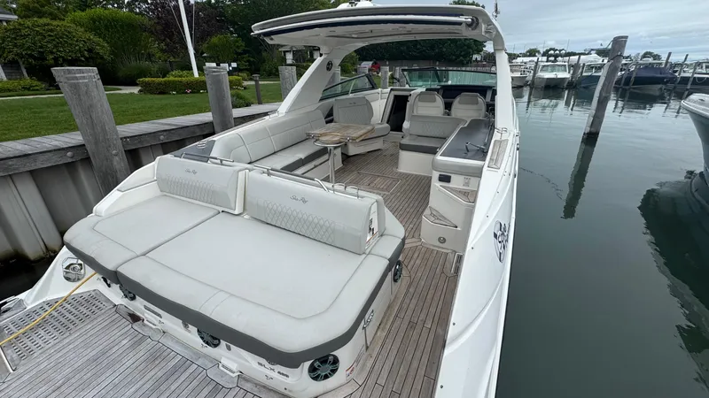 Slide: The Image of 2020 Sea Ray SLX 400 luxury boat with spacious seating at a marina. - 6