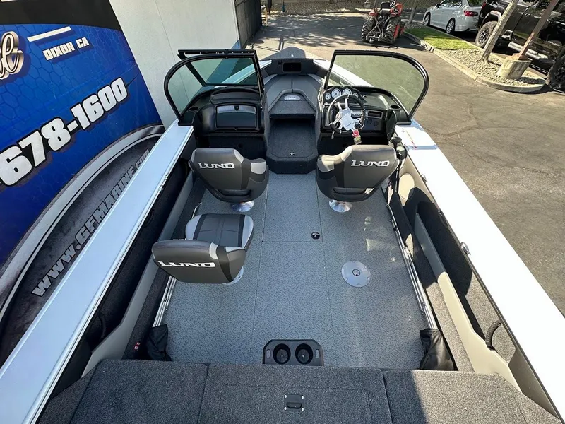 Slide: The Image of 2025 Lund 1875 Crossover XS boat interior with seating and dashboard view. - 11